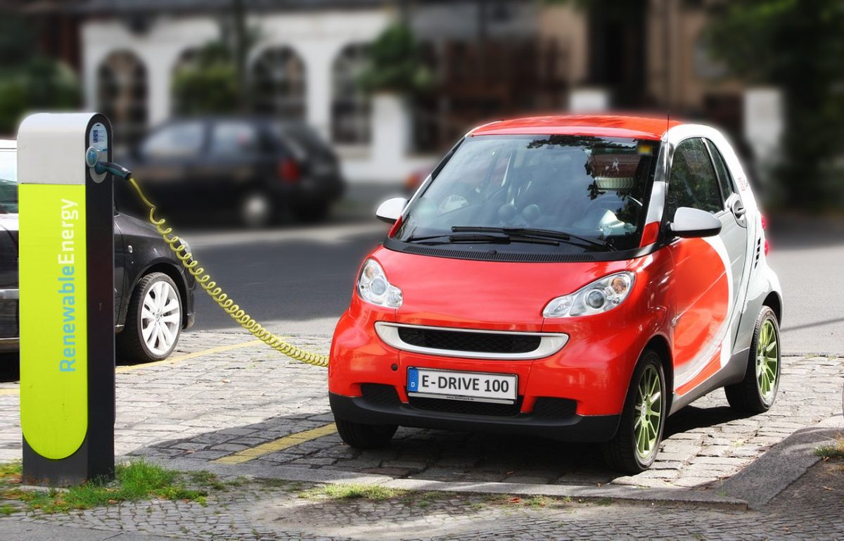 A parked electric vehicle is recharged by an charge point