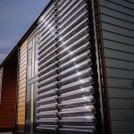 solar thermal tubes on the side of a wooden building