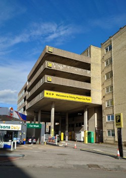 The outside of a multi storey car park with the words NCP and Welcome to Trinity Place car park